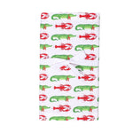 White tea towel with repeating pattern of green alligators and red lobsters tied with a white ribbon