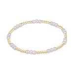 Stretch bracelet featuring alternating gold beads and white pearls