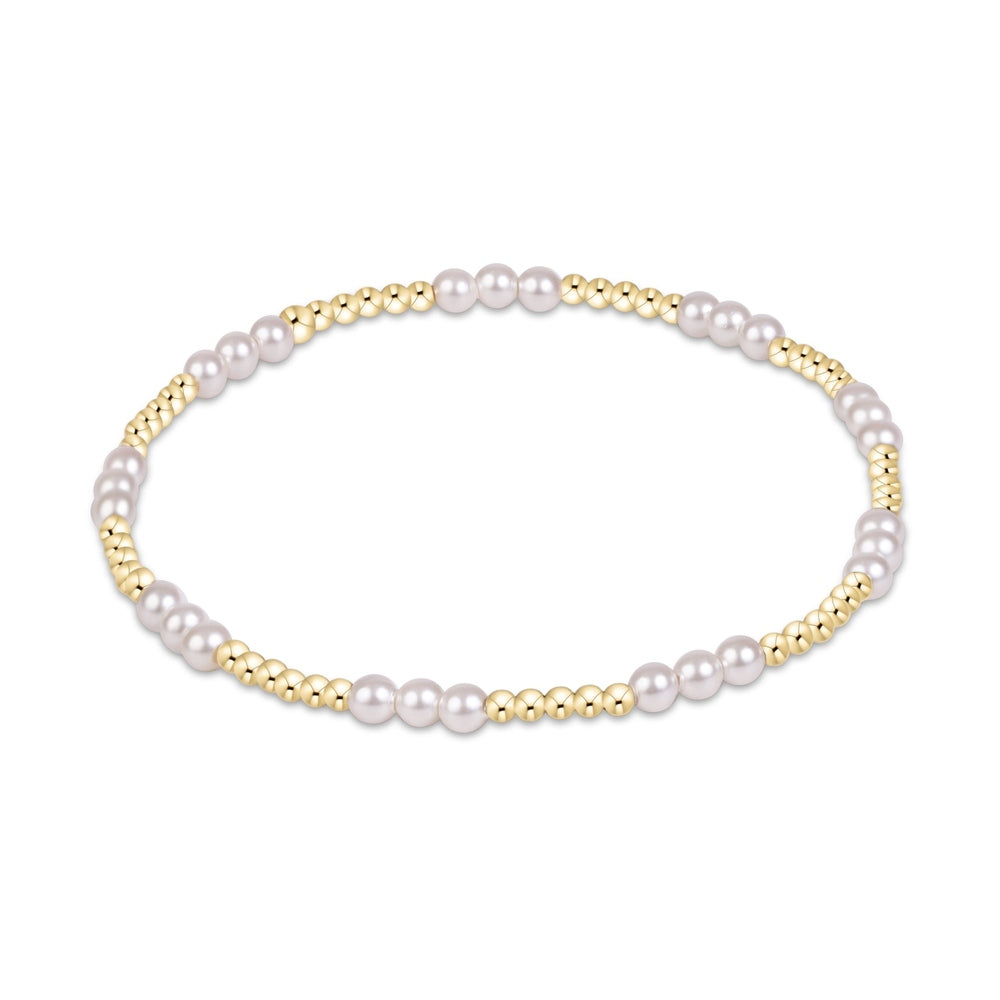 Stretch bracelet featuring alternating gold beads and white pearls