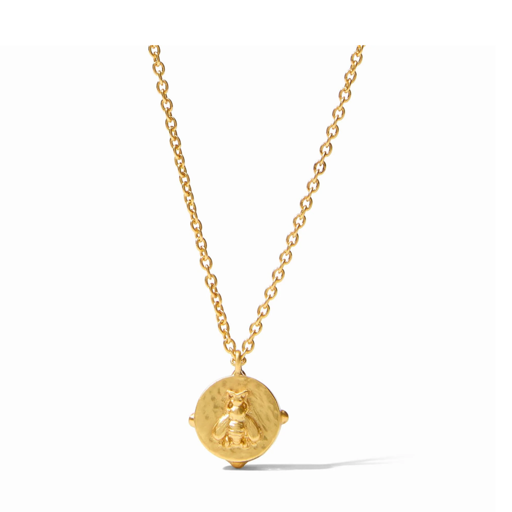 Gold necklace with a round coin pendant featuring a bee motif