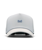 Studio product photograph of a Melin brand light grey performance cap featuring a raised powder blue rubberized logo, a white textured brim, and a decorative braided rope detail on a clean white background