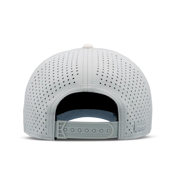 Product photograph of a Melin brand athletic snapback hat in light grey against a white studio background featuring laser-perforated ventilation panels, an adjustable grey closure, and a signature rubberized logo tag