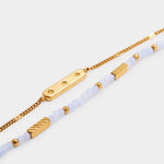 Gold chain bracelet with star engraved bar and beaded bracelet with gold accents