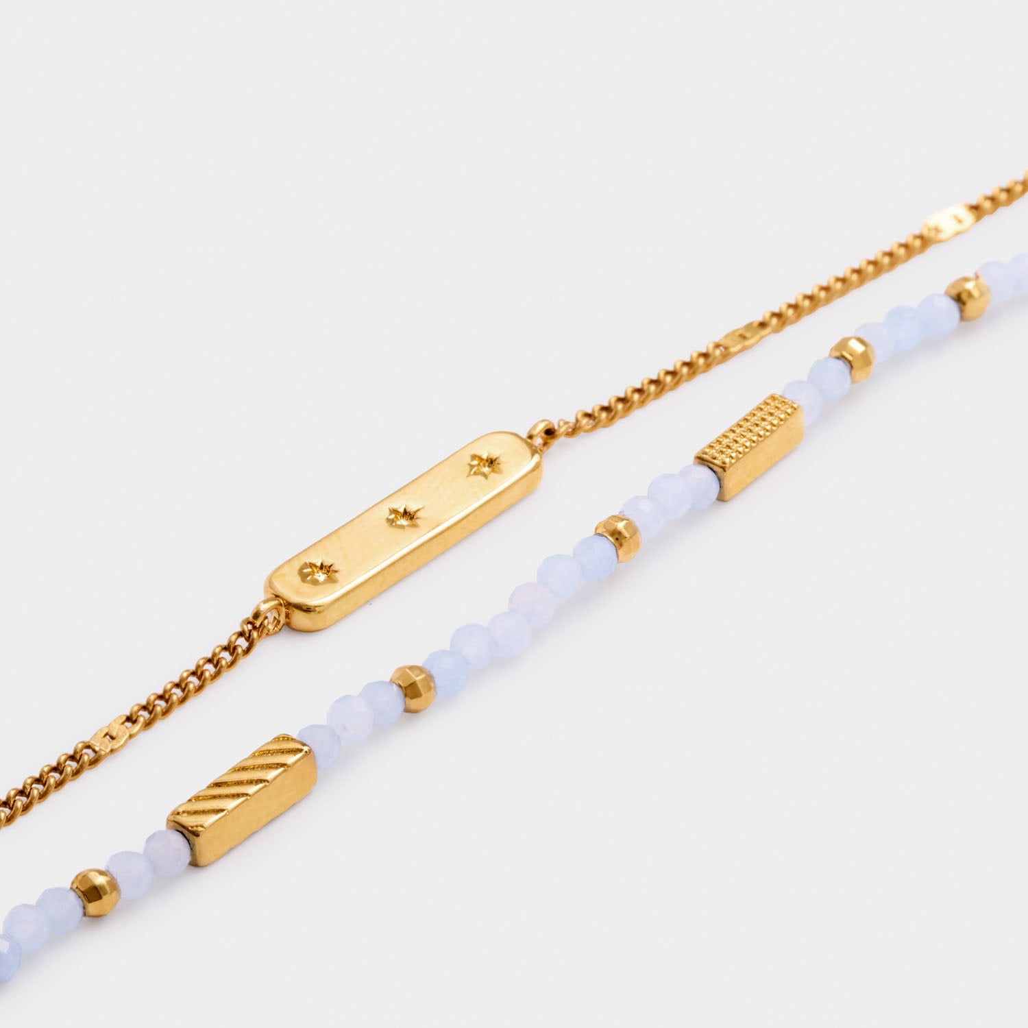 Gold chain bracelet with star engraved bar and beaded bracelet with gold accents