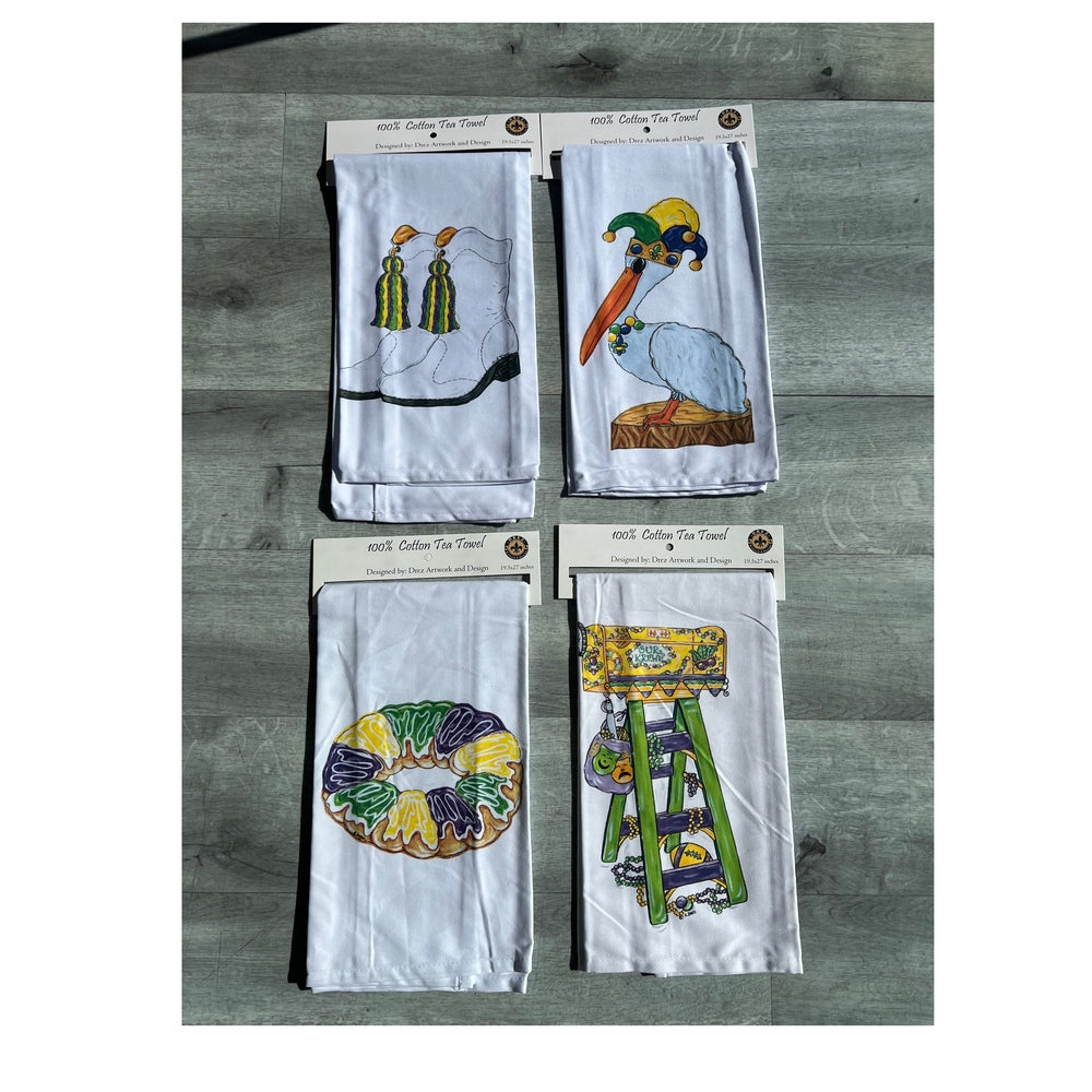 Four Mardi Gras tea towels with tassels, a pelican, king cake and a ladder