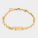 Gold double chain bracelet with pale yellow beads and a central rectangular bar charm featuring three star engravings