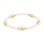 Stretch bracelet with white pearls and gold beads