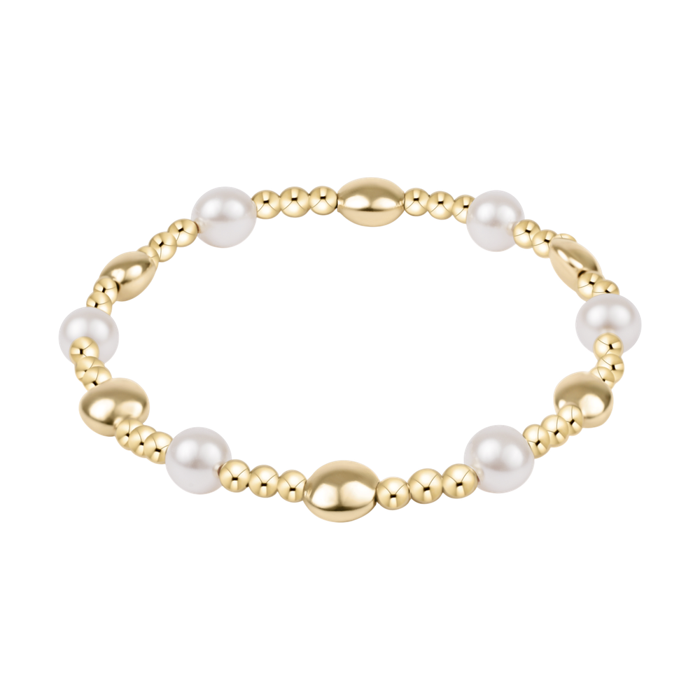 Stretch bracelet with gold beads and white pearls