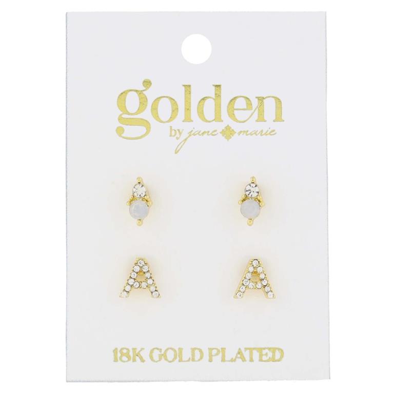 Product photography by Golden by Jane Marie featuring two pairs of 18K gold plated stud earrings on a white display card one pair adorned with clear crystals and light grey stones the other shaped as crystal-encrusted capital A's with the brand's gold script logo