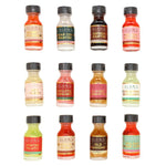 Twelve small bottles of Blant Cocktail Mix arranged in a 3-by-4 grid on a plain white background. Each bottle has a black cap and a colorful label with the Blant brand name and a different cocktail flavor, including Mojito, Margarita, Cosmopolitan, Espresso Martini, Classic Negroni, Christmas Margarita, Winter Mojito, and Old Fashioned.