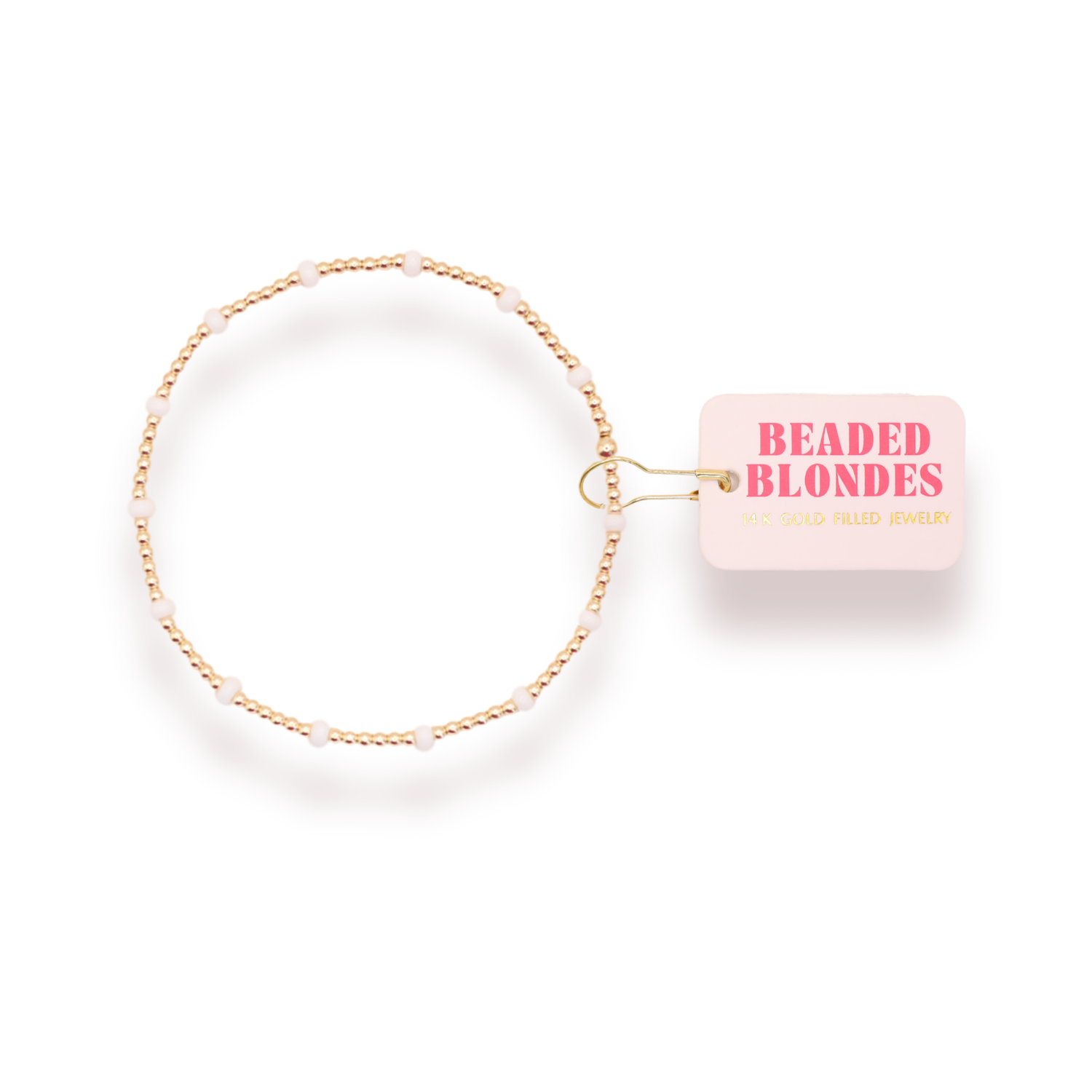 Gold beaded headband with a pink label on a white background