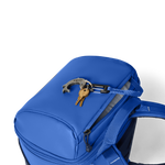 Blue backpack with keys attached on a white background