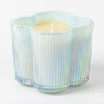 Decorative candle in a glass holder with a striped pattern on a white background