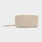 Beige travel toiletry bag with gold zipper on a white background