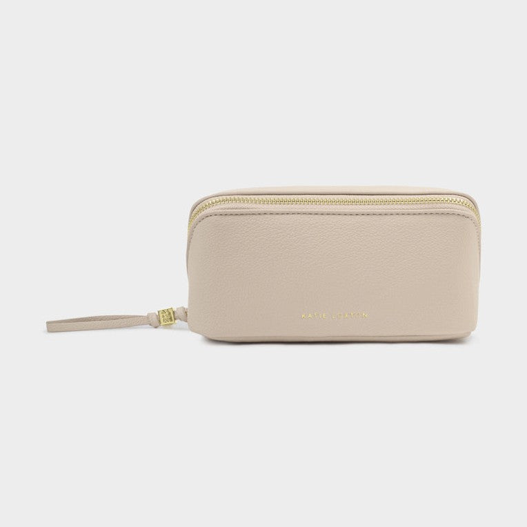 Beige travel toiletry bag with gold zipper on a white background