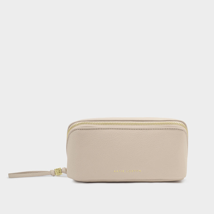 Beige travel toiletry bag with gold zipper on a white background