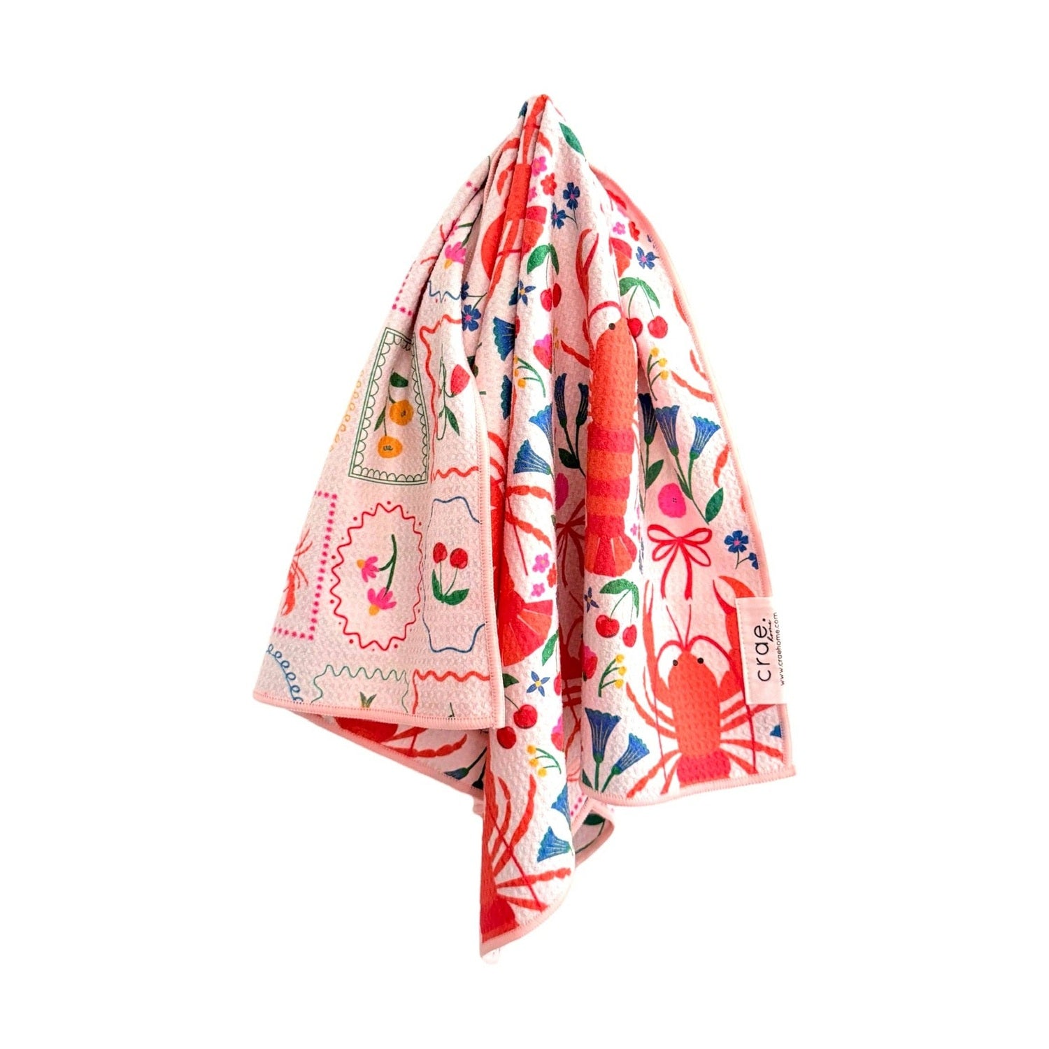 Colorful towel with floral and crawfish patterns on a white background