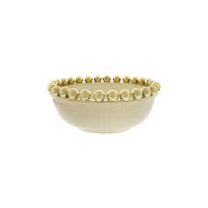Beige ceramic bowl with decorative edge on a white background