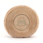 Back of a tan plush macaron with an embroidered round emblem of a cat in a chef's hat