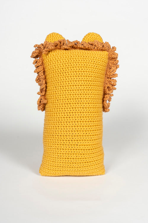 Photograph of a crocheted bright yellow lion-shaped decorative pillow featuring small rounded ears and a textured brown fluffy mane
