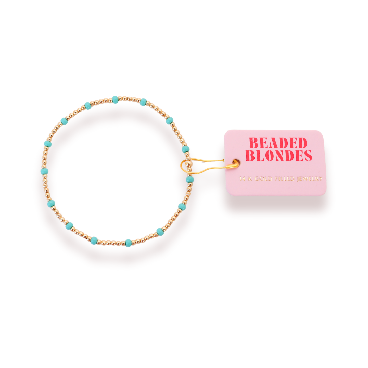 Beaded hair tie with turquoise beads and gold chain on a pink 'Beaded Blondes' packaging.