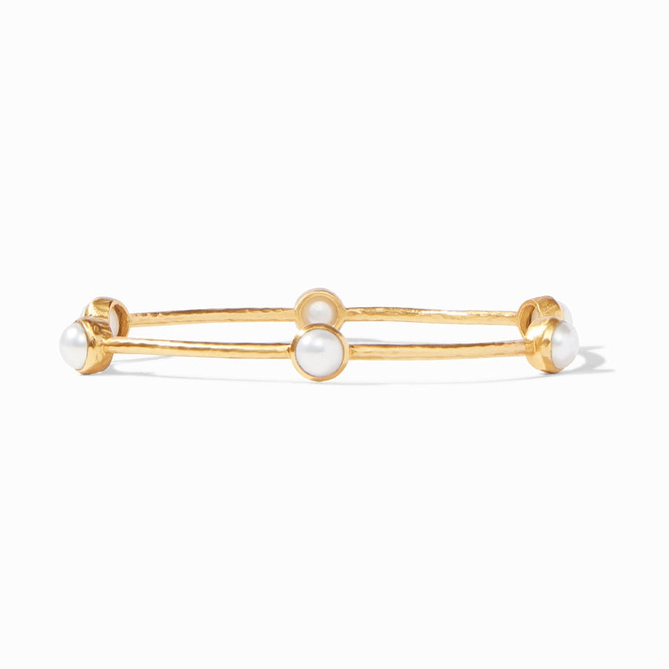 Gold bangle bracelet featuring three evenly spaced white pearls