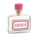 Small glass bottle labeled 'Vodka' with a pink cork on a white background