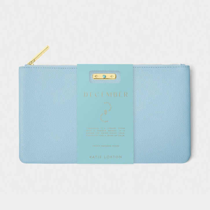 Light blue pouch with gold zipper on a light gray background