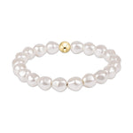 Stretch bracelet featuring white baroque pearls and a single gold bead