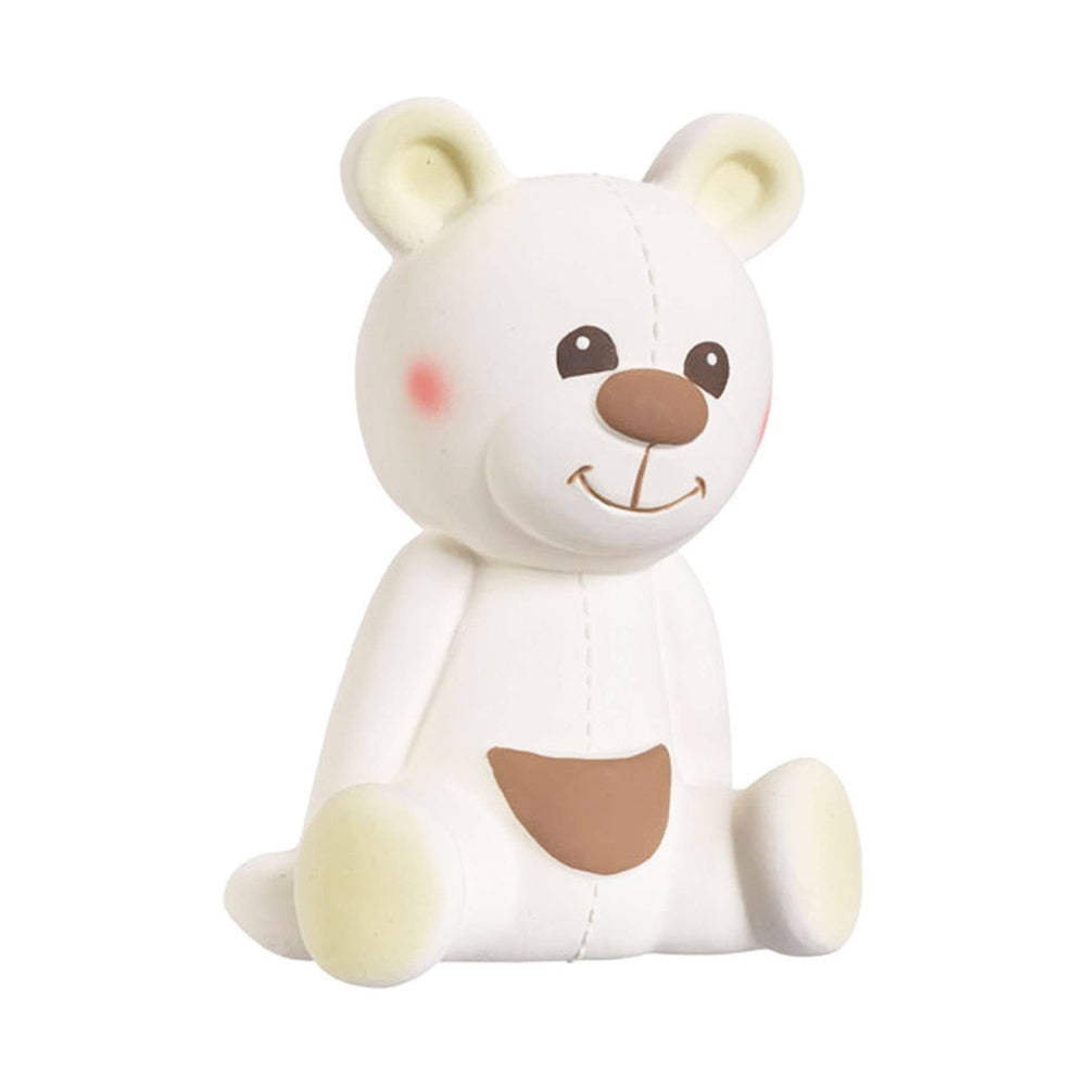 White rubber teddy bear toy with brown nose, pink cheeks, pale yellow ears and feet, sitting