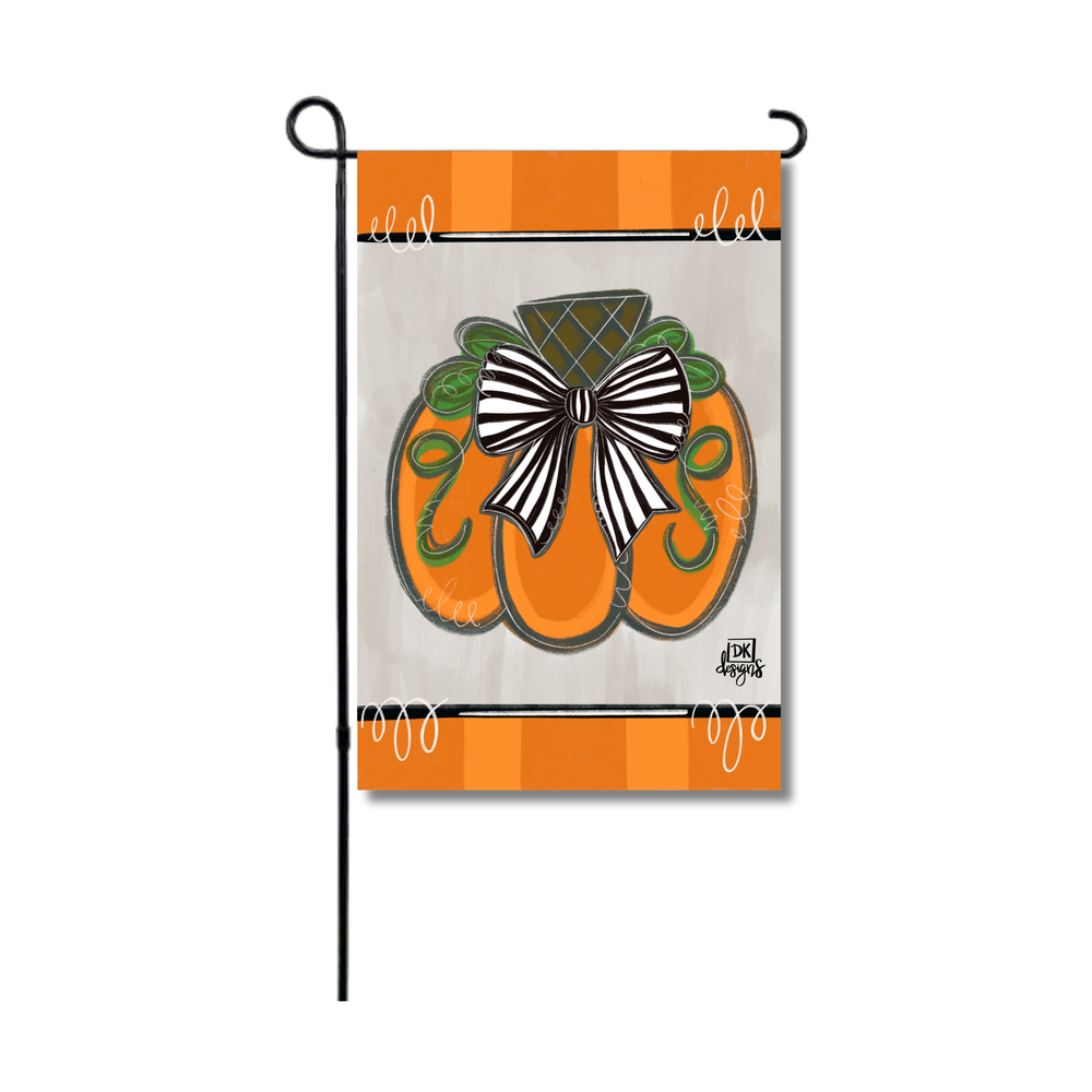 Garden flag featuring an orange pumpkin with a black and white striped bow on a grey background