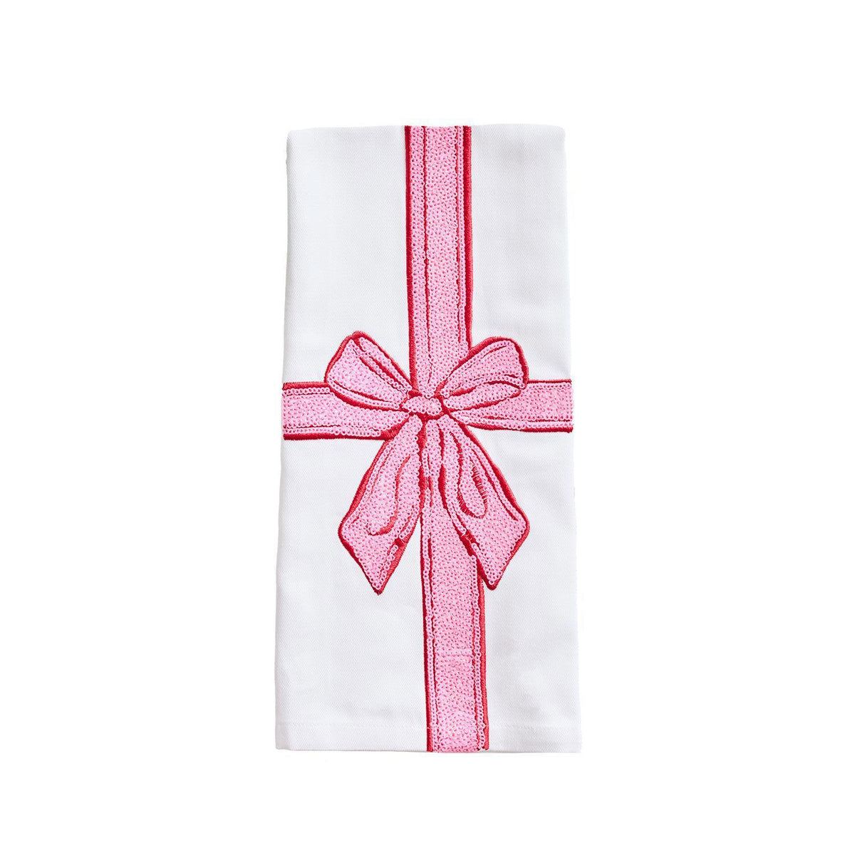White tea towel with a pink ribbon and bow like a wrapped present