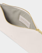 Katie Loxton white vegan leather pouch displayed open to showcase a metallic gold zipper, a grey fabric interior, and an internal brand logo patch against a clean studio backdrop