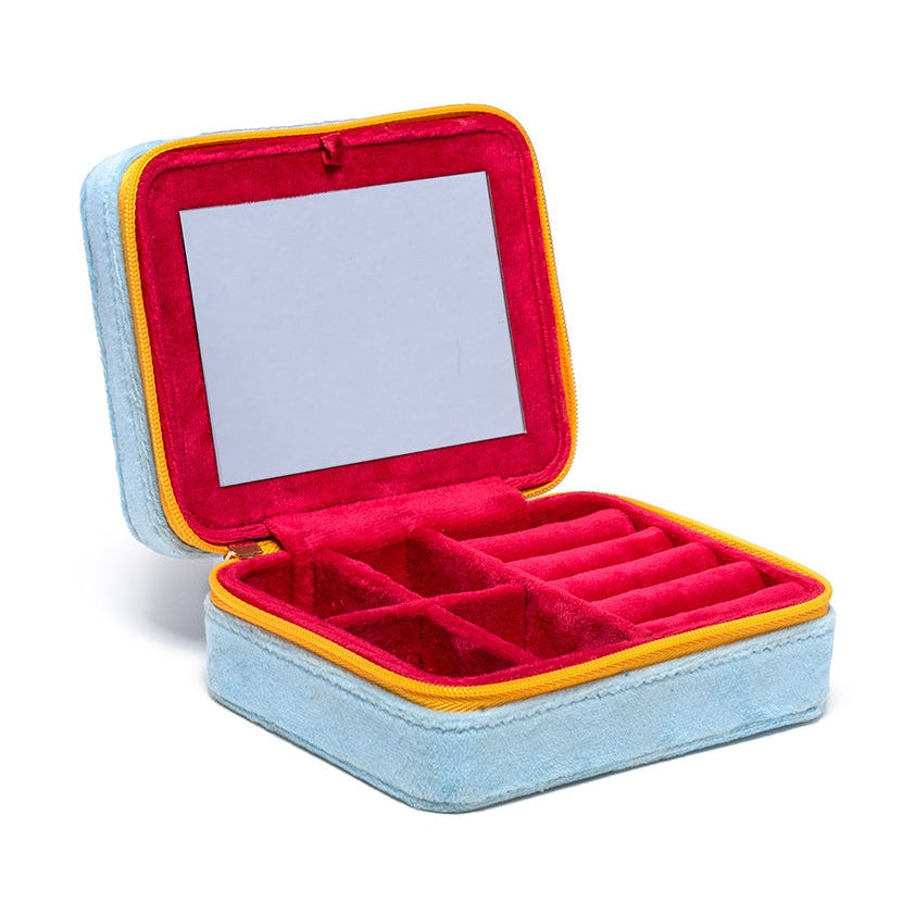 Open blue jewelry case with a red interior, mirror and compartments