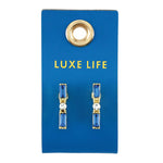 Blue baguette crystal bar earrings on a Luxe Life card