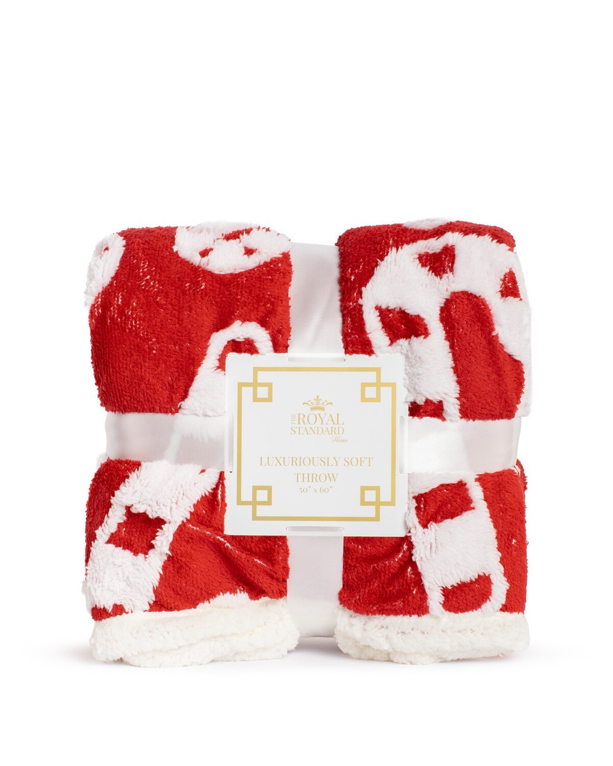 Red and white patterned plush throw blanket folded with a branded product label