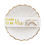 Pair of costume earrings on a 'Soon to be Mrs.' card on a decorative dish.