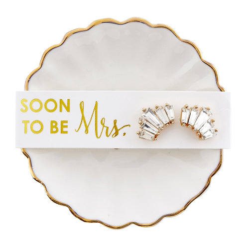 Pair of costume earrings on a 'Soon to be Mrs.' card on a decorative dish.