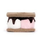 Plush toy resembling a s'more with brown, white, and pink layers on a white background