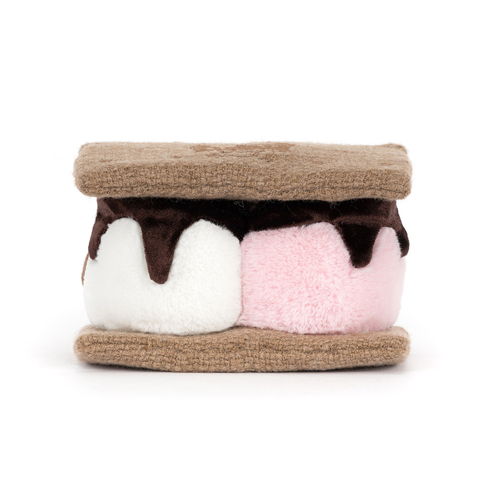 Plush toy resembling a s'more with brown, white, and pink layers on a white background