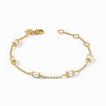 Gold chain bracelet featuring evenly spaced white pearls with textured gold bead accents