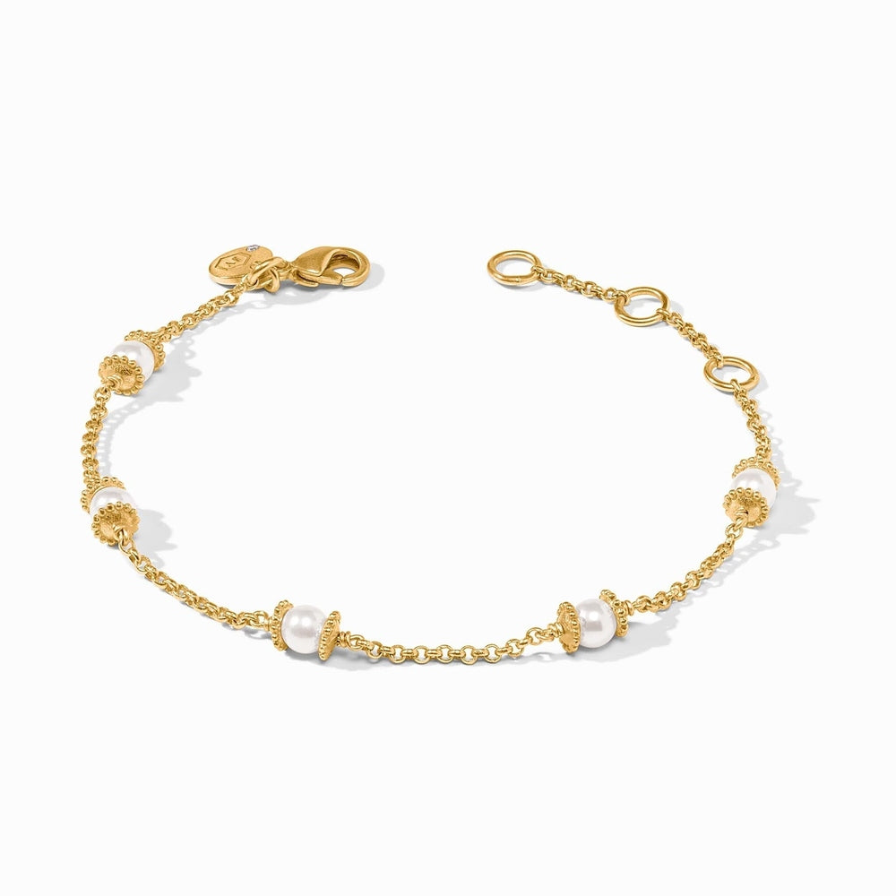 Gold chain bracelet featuring evenly spaced white pearls with textured gold bead accents