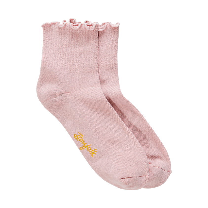 Pink sock with ruffled top and yellow text on a white background