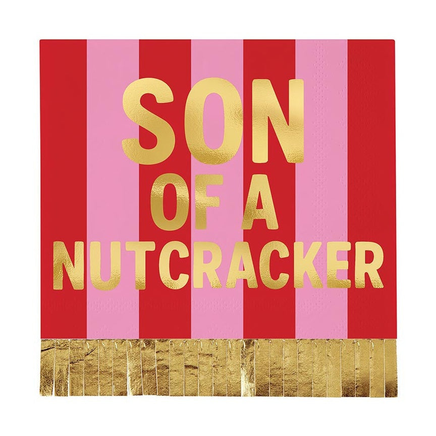 Pink and red striped napkin reading Son of a Nutcracker with gold fringe