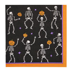 Black paper napkin with a pattern of dancing skeletons and jack o lanterns