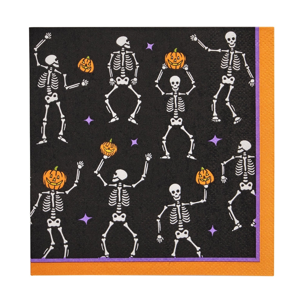 Black paper napkin with a pattern of dancing skeletons and jack o lanterns
