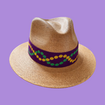 Straw hat band with a colorful band on a purple background