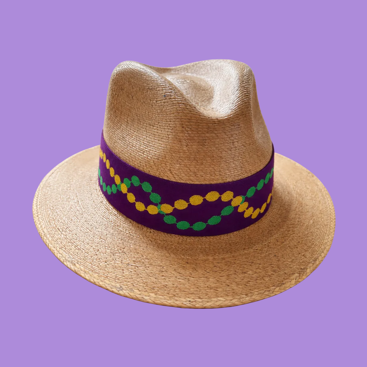 Straw hat band with a colorful band on a purple background
