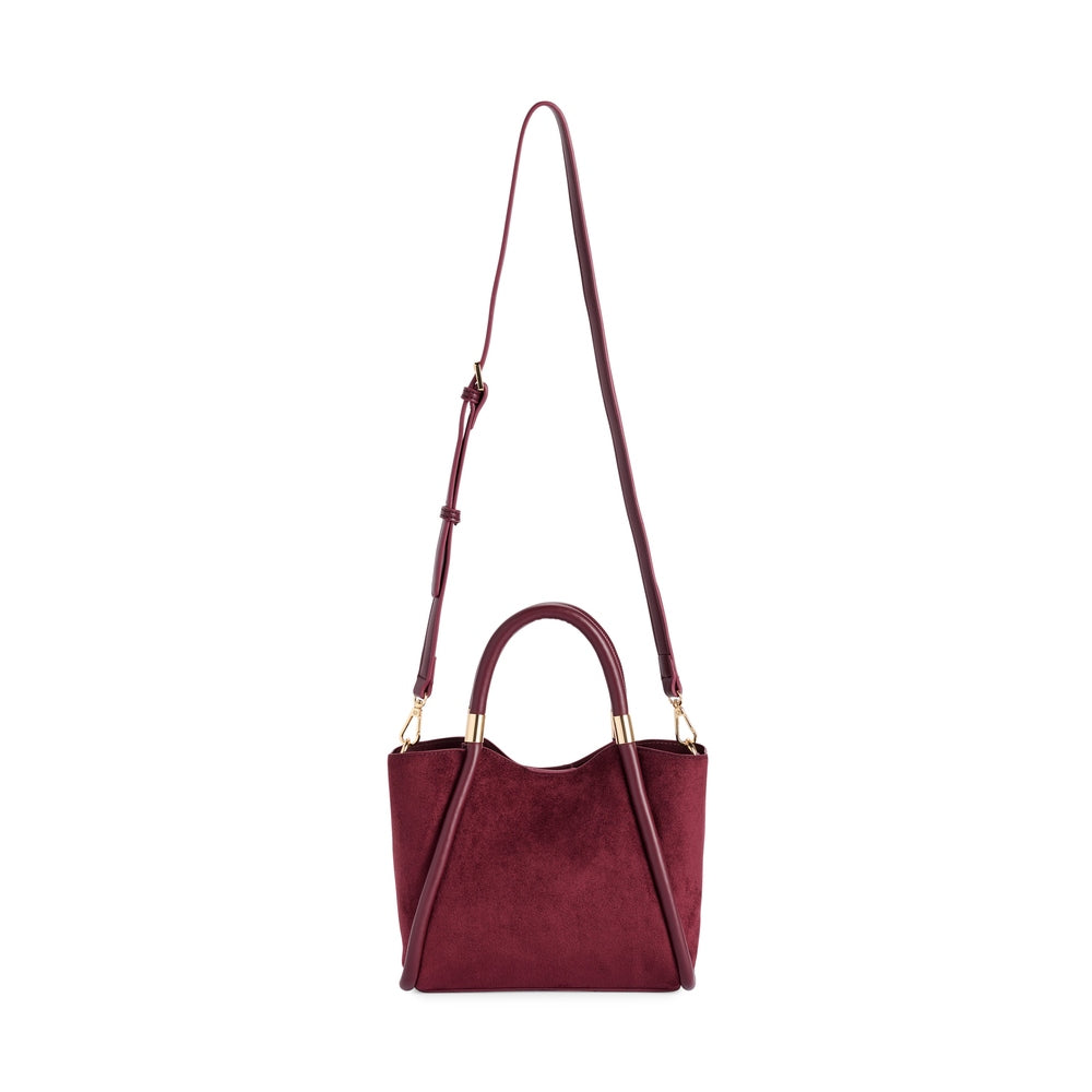Burgundy suede handbag with dual top handles and adjustable shoulder strap