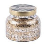 A mercury glass jar candle with a gold lid on a white background